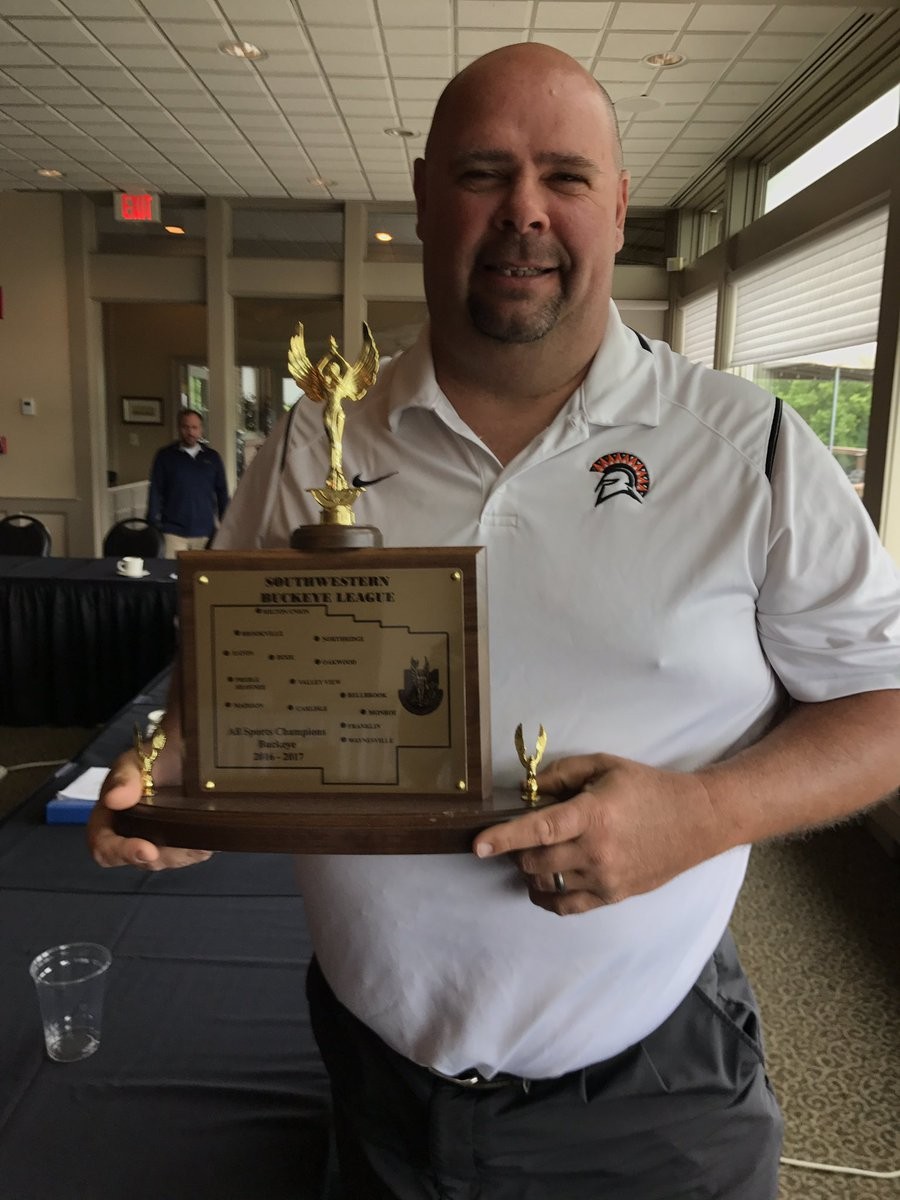 image of a man holding a trophy